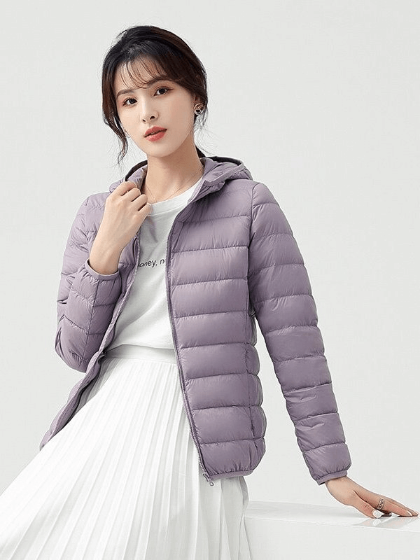 Stylish woman's down jacket with hood in light purple, showcasing lightweight nylon, 90% down content, and ultralight, breathable design.